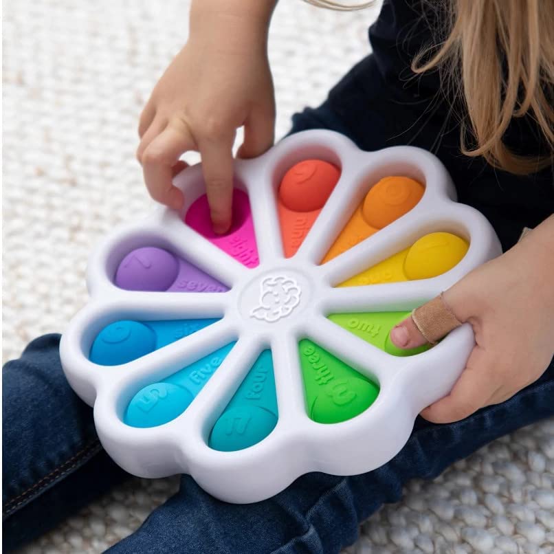 kid holding Fat Brain Toys Original Dimpl Digits Push and Pop Toddlers Educational Toy EN For 2Years+